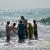Baptizing villagers in the Bay of Bengal.